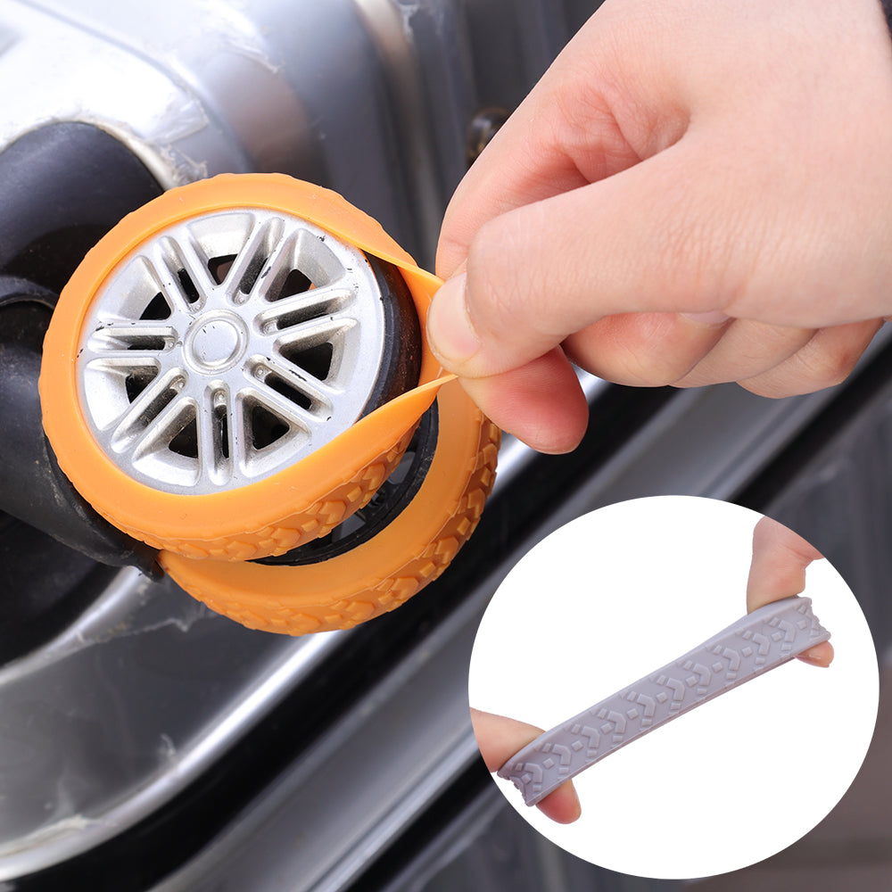 Close-up of orange rubber luggage wheel cover being stretched over a suitcase wheel, highlighting flexible and durable material.