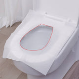Disposable toilet seat cover placed on a toilet seat, showing full coverage for sanitary protection in public or shared bathrooms.