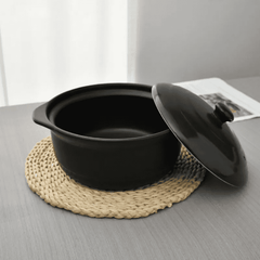 Ceramic Casserole Dish 24 cm with lid shown open on a woven mat, ideal for soups and stews in modern kitchen settings.